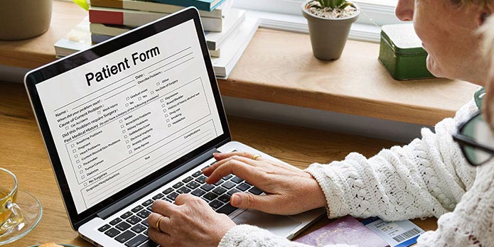 new patient of Eternal Health & Wellness Acupuncture Center filling out forms online before his appointment